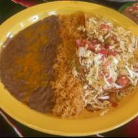Enchiladas Jalisco · 2 soft tortilla stuffed with your choice of chicken or shredded beef, Mexican cheese, cabbag...