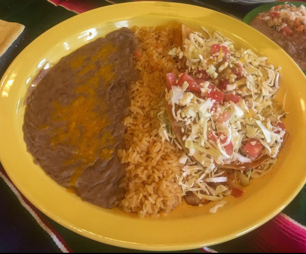 Enchiladas Jalisco · 2 soft tortilla stuffed with your choice of chicken or shredded beef, Mexican cheese, cabbage, tomatoes and sauce.