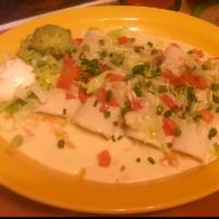 Enchiladas Adelitas · 4 enchiladas: 1 chicken, 1 shredded beef, 1 ground beef and 1 cheese. Topped with cheese dip...