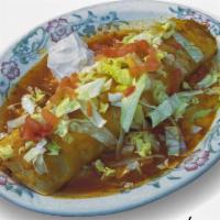 Macho Burrito · A super burrito filled with rice, beans, cheese and your choice of meat filling. Covered wit...