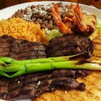 Mexican Trio · Charcoal sliced steak, grilled chicken breast and Monterey Jack shrimp. Covered with delicio...
