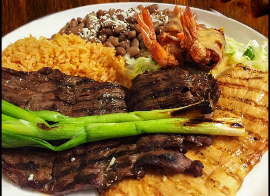 Mexican Trio · Charcoal sliced steak, grilled chicken breast and Monterey Jack shrimp. Covered with delicious tomato sauce. Served with rice and ranchio beans.