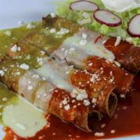Enchiladas Banderas · 4 crispy corn tortillas stuffed with chicken or shredded beef. Garnished with ranchero chees...
