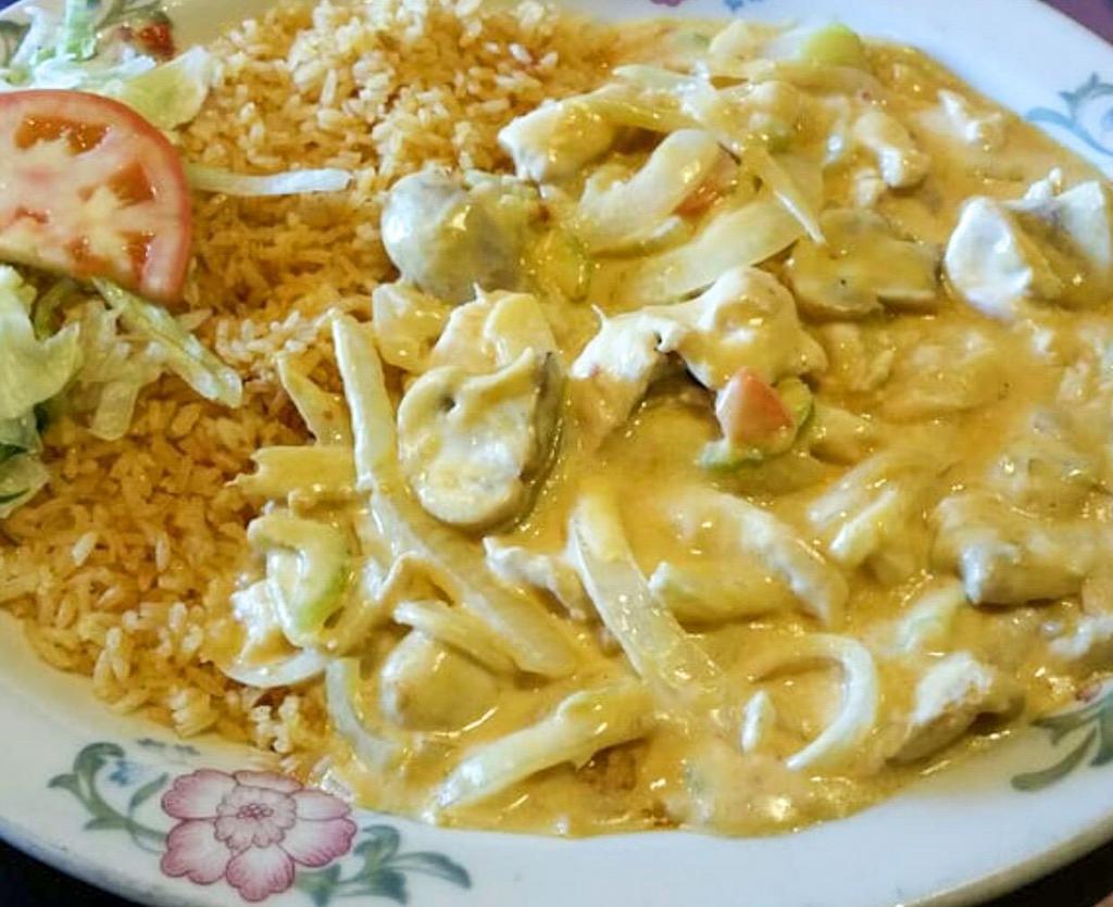 Pollo a la Crema · Boneless chicken in delicious Parmesan cheese cream sauce with mushrooms, carrots, celery and onions. Served with rice and salad.