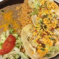 Tacos de Pescado · 3 soft tacos with fillet fish, special sauce, onions, tomato, cilantro and lettuce.