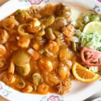 Arroz con Camarones · Prawns sauteed with mushrooms, celery, carrots, onions and unique sauce on a bed of rice and...