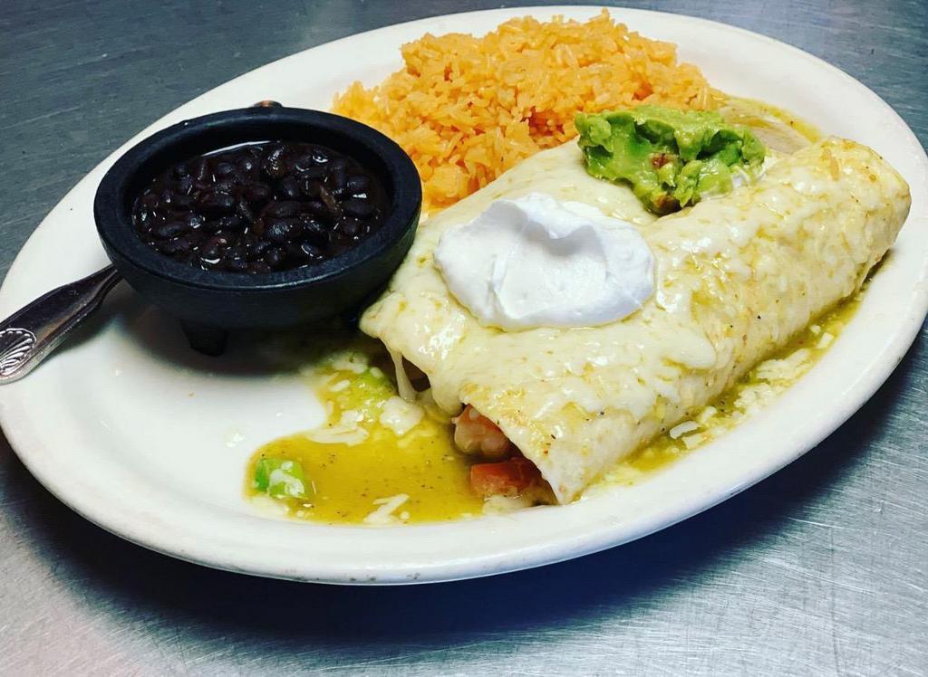 Shrimp Enchiladas · 2 soft flour tortillas filled with seasoned shrimp with tomatoes, green onions and parsley. Covered with a delicious sauce. Served with rice and beans.