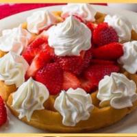 Waffle with Strawberries and whipped cream · Served with strawberries and whipped cream.