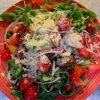 Arugula Salad · Fresh arugula topped with plum tomatoes, red onion, olive oil, balsamic & shaved Romano.