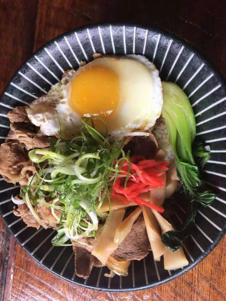 9. Gyu Don · Jalapnese rice topped with beef, scallion, red ginger and onion, simmer in a mildly sweet sauce flavored with dashi, soy sauce and mirin, topped with a sunny side up egg.