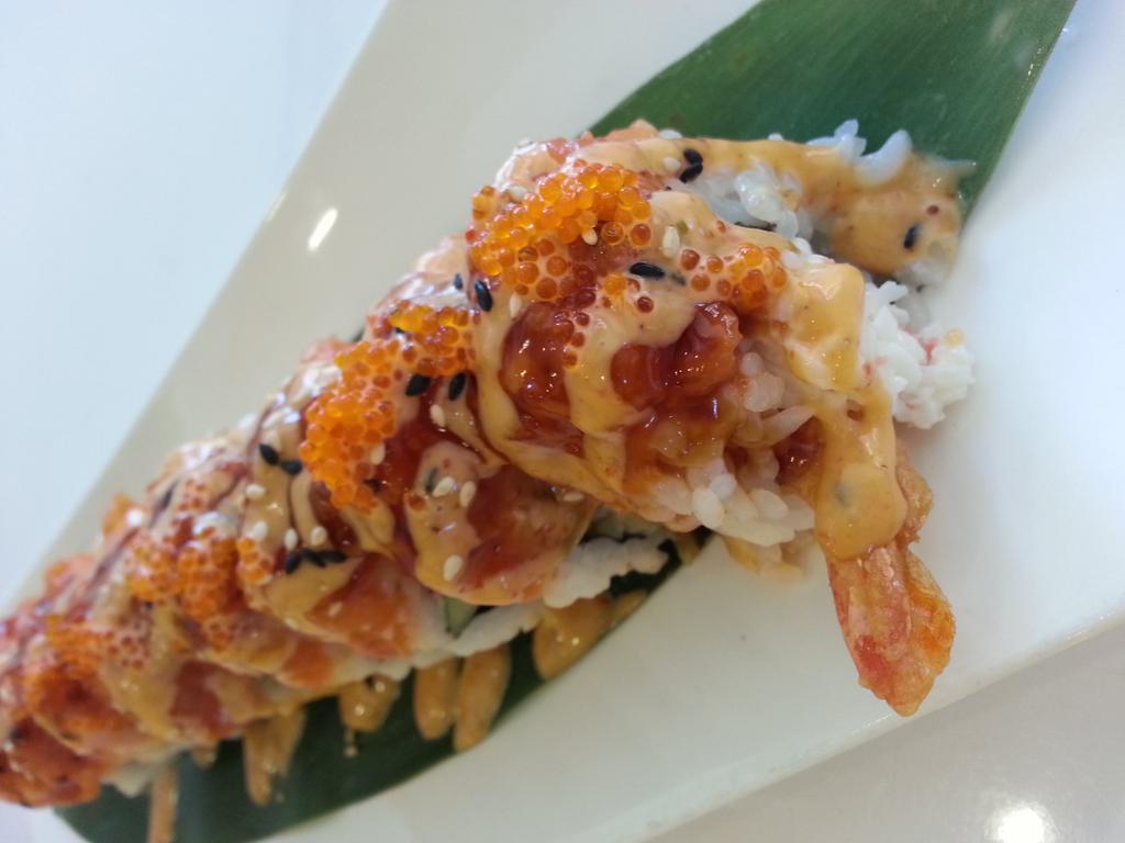 Orange Dragon Roll · Shrimp tempura, crab meat & cucumber topped with marinated salmon, tobiko, eel sauce & spicy mayo.