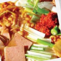 Budae Stew · Spicy stew with ramen, spam, sausage, rice cake, fishcake, & tofu.