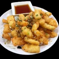 Salt and Pepper Calamari · Crispy calamari battered and fried with garlic and scallions served with a side of tempura s...