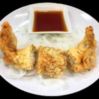 Soft Shelled Crab · Soft shelled crab lightly coated with tempura batter, served with thinly sliced onions and a...
