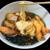 Udon Noodle Soup · Thick Japanese udon noodles in a broth with tofu skin, Japanese fish cakes, scallions and eg...