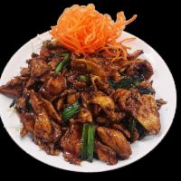 Mongolian Chicken · Stir-fried chicken with scallions and served in a sweet brown sauce on top of crispy noodles...