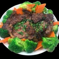 Thai BBQ Beef · Thai style grilled marinated beef served with carrots and broccoli, choice of rice and eithe...