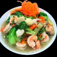 Oceans Trio · Shrimp, scallops, lobster meat stir-fried in a Thai white sauce with mushrooms, broccoli, zu...
