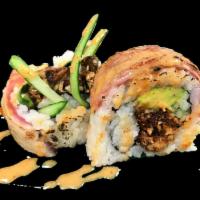 Sneaky Spider Roll · Soft shell crab tempura, cucumber and avocado topped with seared tuna, seared filet Mignon a...