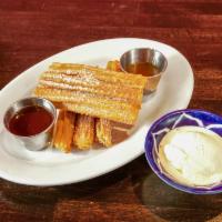 Fried Churros · Caramel sauce served with chocolate and vanilla ice cream.