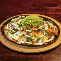 Frida Nachos · Choice of chicken, steak, chorizo. Pickled jalapenos, beans, guacamole, pico de gallo and cr...