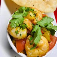 7. Shrimp Pori · Shrimp cooked in Bengali style served with poori bread.