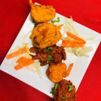 16. Vegetables Pakoras · 4 pieces. Mixed vegetable deep fried with chana flower.