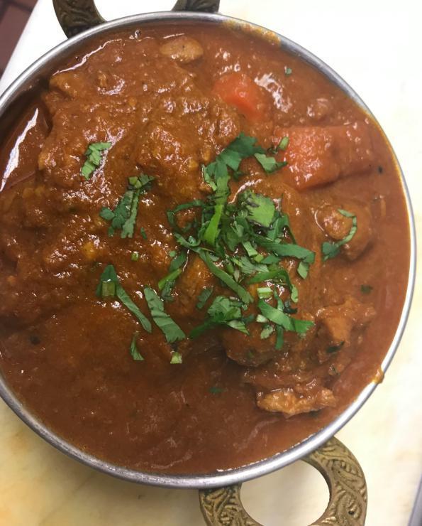 58. Bhuna (Medium) · Cooked with medium special sauce, garlic, ginger, and fresh herbs and spices.