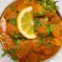 61. Curry (Mild) · Cooked with ginger and garlic in ground onions, tomatoes and mild curry sauce.