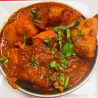 64. Madras (Fairly Hot) · Cooked with tomato and medium curry sauce.