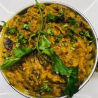 81. Daal Makhni · Mixed black grain lentils with tomato flavor. Served with basmati rice.
