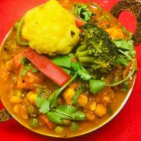 82. Mixed Vegetable Curry · Seasonal vegetables cooked with spices, onions and tomatoes. Served with basmati rice.