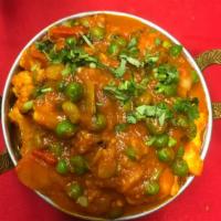90. Aloo Mutter Gobi · Potatoes, peas and cauliflower cooked with mild spices. Served with basmati rice.