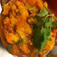95. Gobi Bhaji · Cooked with cauliflower, tomatoes and onion. Served with basmati rice.