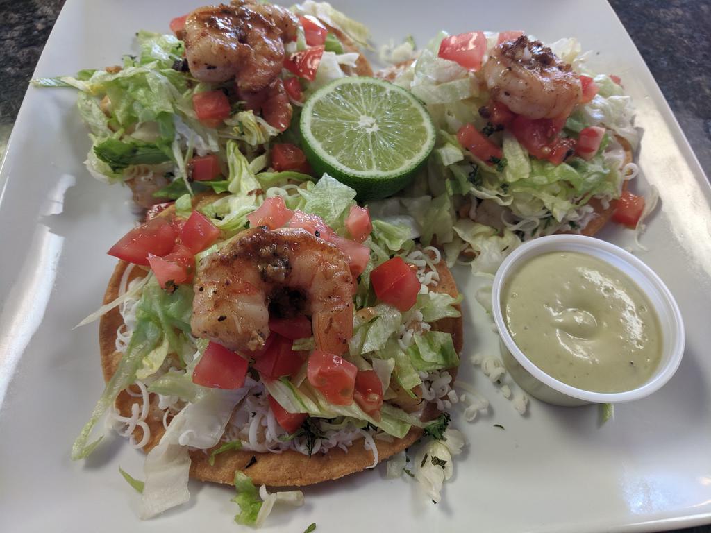 Shrimp tostada's plate · 3 shrimp tostadas, with mayo, chipotle sauce, cheese, lettuce, tomatoes 