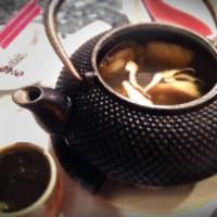Tea Pot Soup · Shrimp, eel, white fish and mushroom in clear soup served in iron tea pot.  