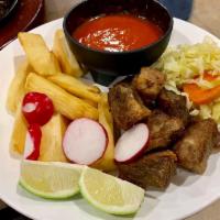 Yuca con Chicharron · Fried yucca and pork meat with delicious red sauce.