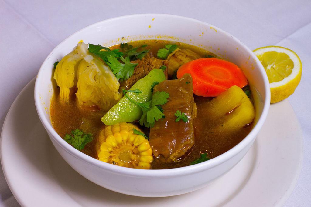 Sopa de Res · Beef short rib soup, served with fresh vegetables, yellow corn, green cabbage, sliced carrot, cassava, chayote, and plantain.