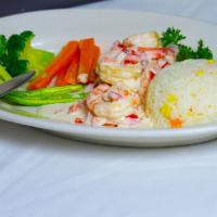 Salmon a la Crema · Grilled salmon with heavy cream and three shrimps on top, served with sauteed mixed vegetabl...