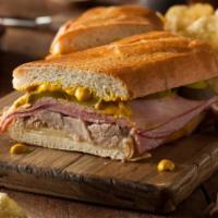 Sandwich Cubano · Sandwich cubano con jamon, queso suizo, cerdo, mostaza, mayonesa y pepinillo, servido en pan...