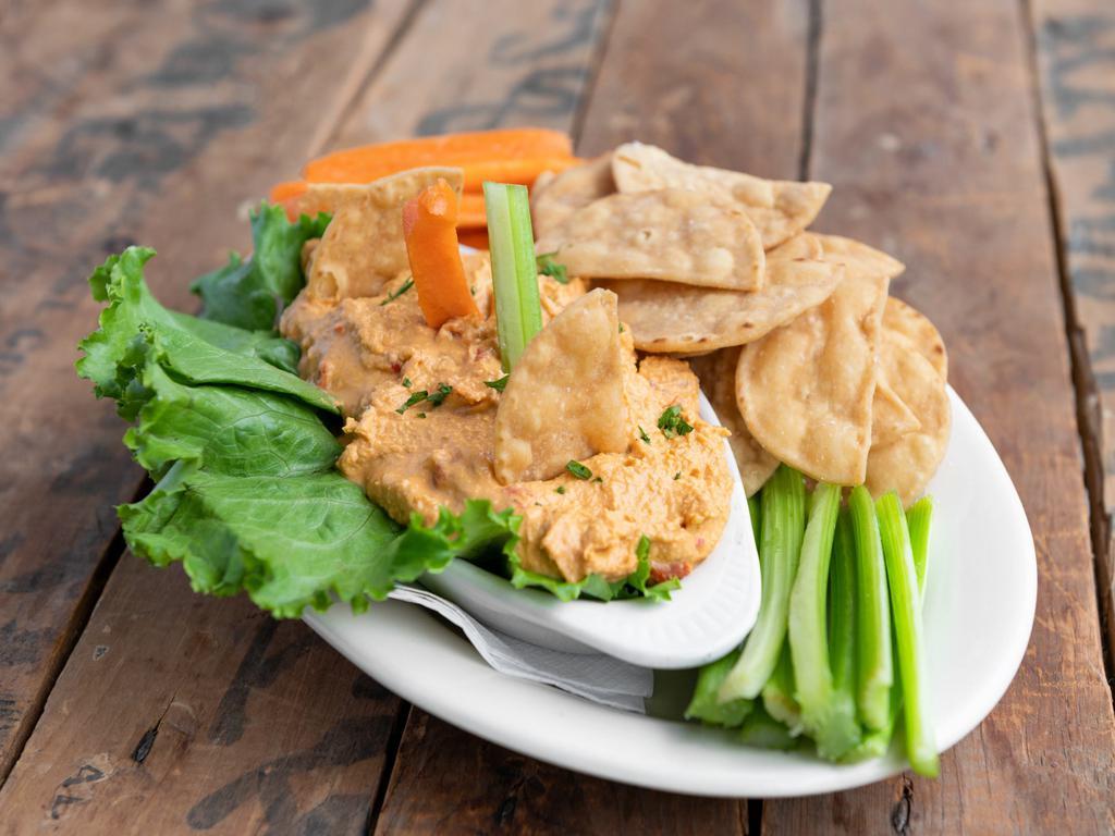 Hummus · Roasted red pepper hummus.  Served with pita chips or Parisian bread