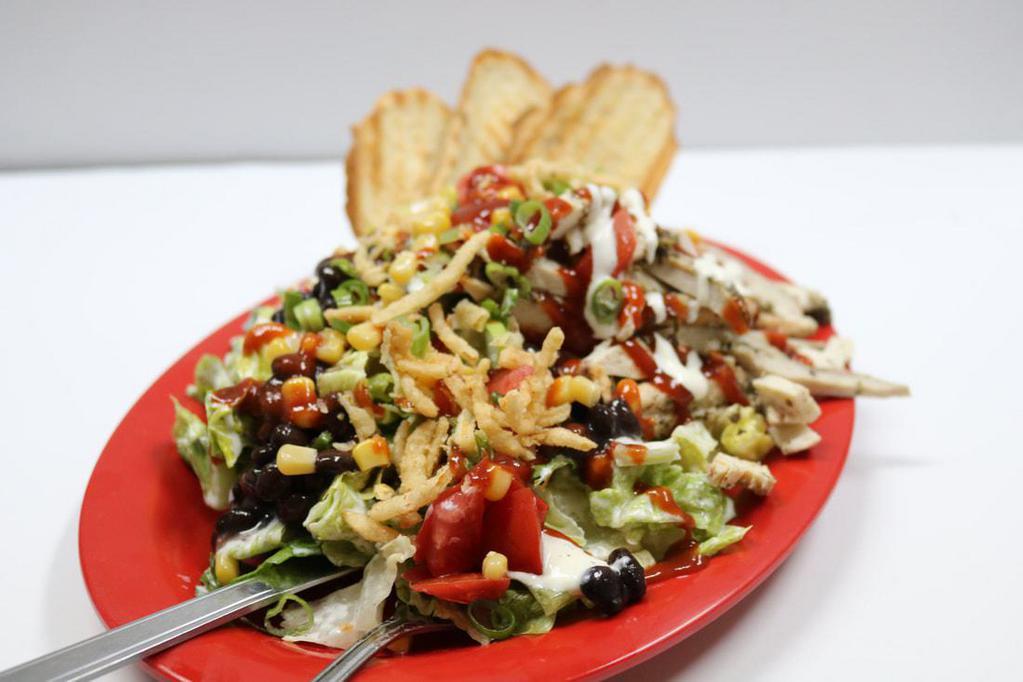 BBQ Chicken Salad · Romaine lettuce, ranch dressing, black beans, corn, green onion, fried onion, tomatoes and chicken.
