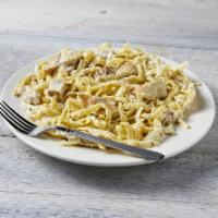 Fettuccini Chicken Alfredo · Fettuccini pasta with chicken covered in our homemade Alfredo sauce topped with Parmesan che...