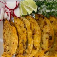  Three Quesabirria  · Order of Three Quesabirrias
Corn tortillas and red-stained,  crisping,  shredded cheese on t...