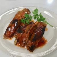 BBQ Ribs · Tender pork ribs marinated with homemade BBQ sauce.
