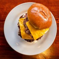 Double Cheeseburger · Two charbroiled 1/3 lb cheeseburgers. Served on a brioche bun with mustard, ketchup, pickles...