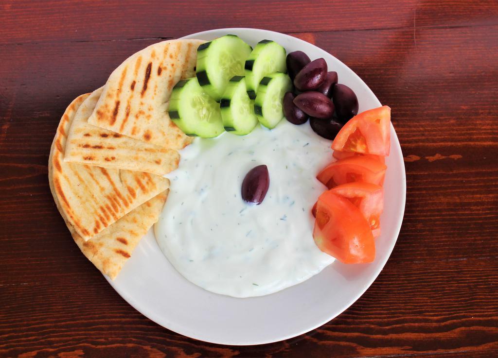 Tzatziki Dip Plate · Cucumber garlic sauce. Served with tomato, cucumber, olives and warm pita bread.