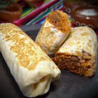 Burrito · Choice of: *Asada,  Chicken, or Pastor, comes with whole pinto beans , rice, onions and cila...