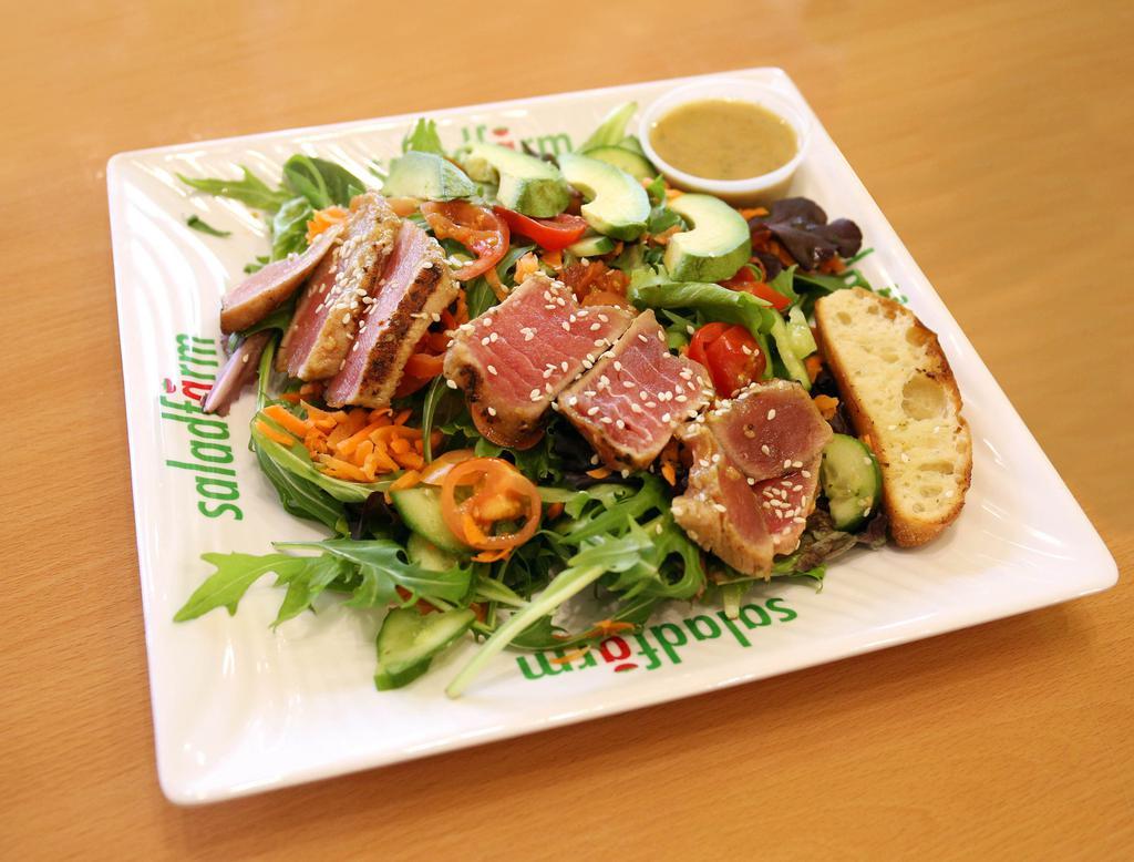 10. Seared Tuna Salad · Organic baby field greens, julienne cut carrots, grape tomatoes, Persian cucumbers, scallions, topped with seared tuna, and Hass avocado served with our ponzu dressing.