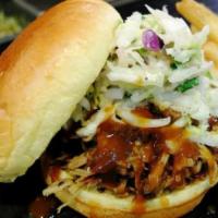 Pulled Pork Sandwich · Drizzled with BBQ sauce and topped with jalapeno coleslaw.